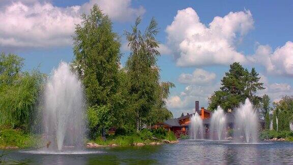 城市公园里的喷泉自然景观有绿树、湖泊、喷泉
