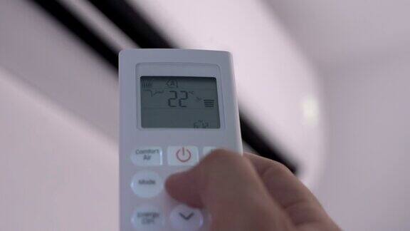 用手按住分体空调的控制按钮将温度提高到25摄氏度的建议温度