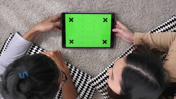 夫妇在家里使用绿色屏幕的数字平板电脑