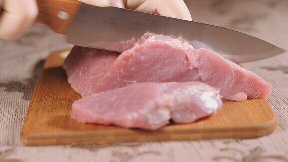 金属刀切肉在木板上切肉波克是董事会成员猪肉片库克的手上戴着乳胶手套