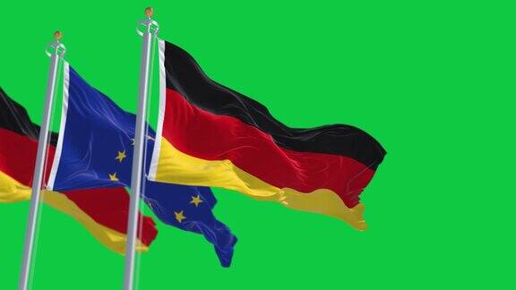 德国和欧盟的旗帜在绿色的背景上分别飘扬