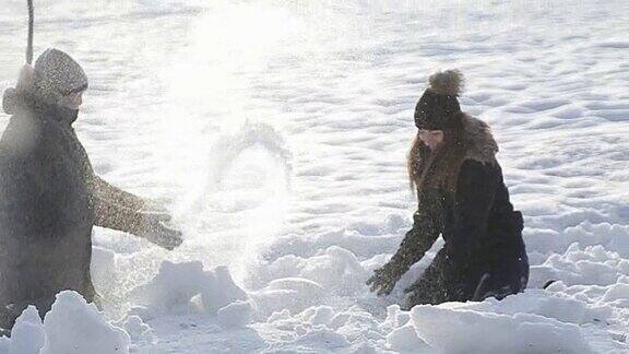 一对恩爱的夫妇在童话般的冬天玩雪球