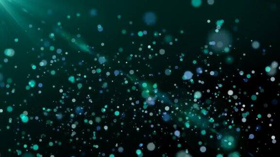 闪光粒子在黑暗的背景蓝绿色主题