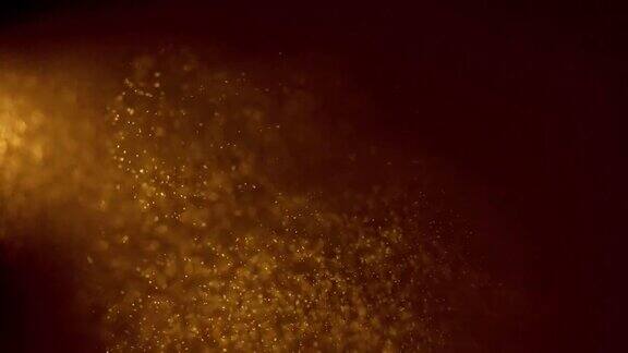 金色的颗粒漂浮在空中神奇的背景模糊的散景背景下的金粉颗粒慢慢漂浮在空中