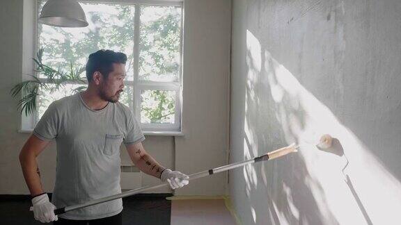 日本一名男子用油漆滚筒刷墙