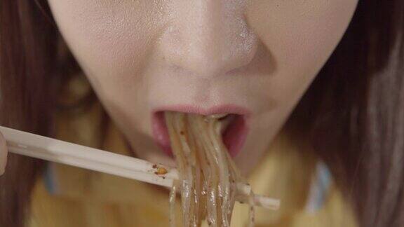 亚洲女人吃面条的特写镜头