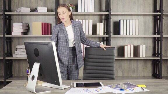 年轻女性站着走着在线开会看着电脑喝着咖啡在工作场所看起来很聪明漂亮的年轻女性看起来像商人或工作在公司办公室的工作人员