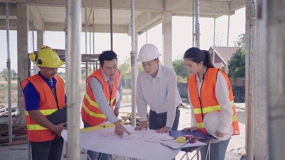 一名年轻的工程师男工头和女工头工头建筑工人与房屋计划会面