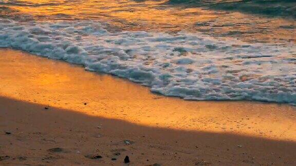 非常美丽的日落在海边沙滩和海浪拍打着沙滩
