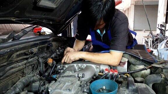 亚洲发动机技师正在修理发动机