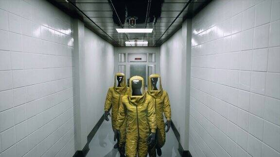 身着化学防护服的病毒学家沿着医院大楼的走廊行走穿着特殊防护服的医生这部动画非常适合世界末日或医学背景