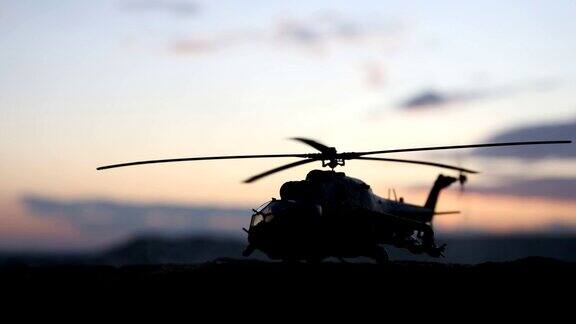 军用直升机的剪影准备从冲突地区起飞装饰的夜晚镜头与直升机开始在沙漠与雾色调背光有选择性的重点战争