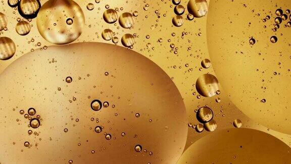 微距拍摄金黄冒泡油圆球体水泡沫极端接近抽象智能手机的主屏幕风格主题背景金色球体震动爆炸能源