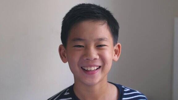 一张快乐、自信、健康的亚洲混血儿十多岁男孩的大头照