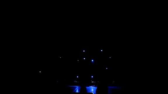 黑暗中空荡荡的舞台上蓝光闪烁白光闪烁舞台灯光