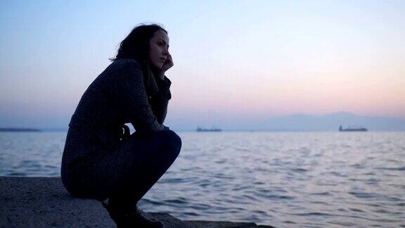 坐在海边沉思的女人