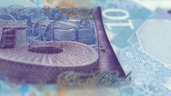 10里亚尔的卡塔尔纸币观察和储备侧跟踪多利拍摄的10卡塔尔纸币目前10里亚尔纸币4k分辨率股票视频-卡塔尔货币货币背景金融通货膨胀