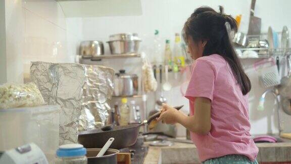 亚洲女孩在厨房里自己做爆米花生活理念