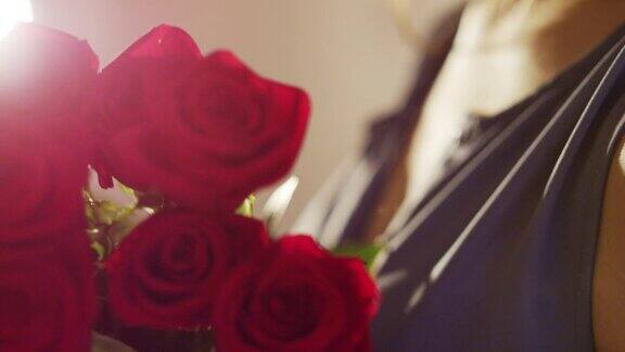 女子手持一束红玫瑰