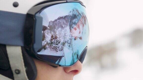 一个微笑的滑雪者在山上度假的肖像在她的身后你可以看到白雪覆盖的山