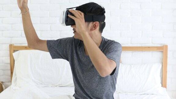 男人戴着VR头戴在客厅用控制器玩游戏