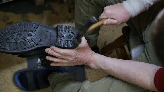 俯视图鞋匠用锤子敲击鞋底的鞋