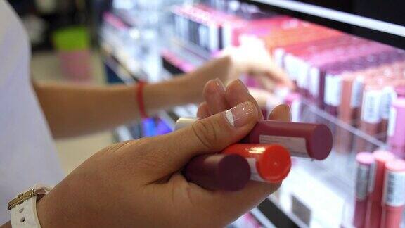 女人在化妆品美容店选择口红特写镜头