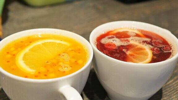 两种红色和黄色杯子里的水果和浆果饮料