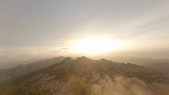 FPV视频高山冲浪在云上高速飞行与花岗岩山脉在日出照明坦皮奥包萨尼亚撒丁岛意大利
