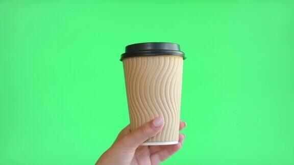 手拿咖啡杯的女人外卖手拿热饮标志模型的纸杯与盖子隔离在绿色色度的关键空白广告背景零浪费无塑料