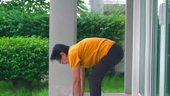 亚洲老年妇女早上锻炼时伸展身体触摸脚趾