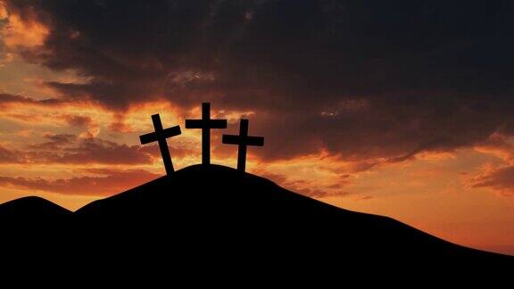 三个基督教十字架符号的剪影与橙色的日出天空
