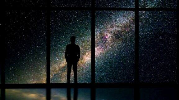 在布满星星的天空背景下站在窗边的那个人时间流逝