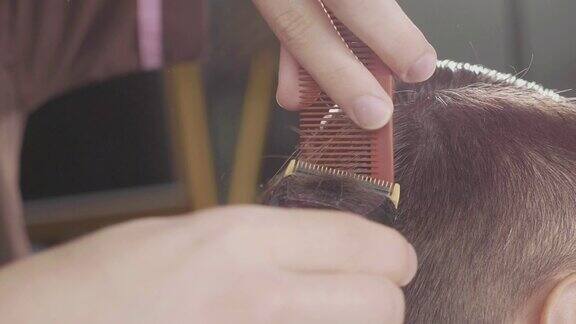 男理发师用电动剃须刀慢动作理发
