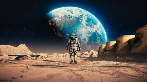 勇敢的宇航员穿着太空服自信地在火星上走向地球空间站和火星漫游者被岩石覆盖的外星红色星球