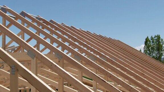无人机拍摄的一排木屋顶桁架在一个阳光明媚的日子在一个建筑工地