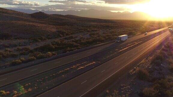 无人机航拍黄昏时刻大货车在高速公路上疾驰