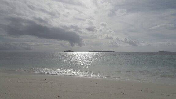 美丽的晴天在一个平静的原始海滩与灰色的天空在印度尼西亚