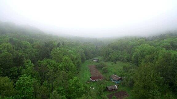 天线无人机在晨雾中飞过村庄