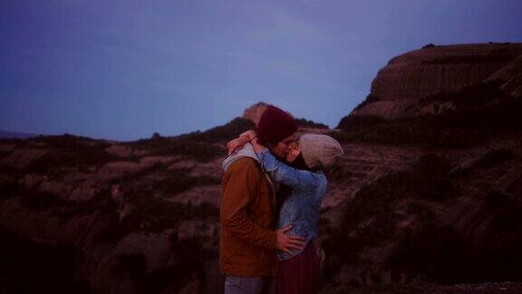 快乐的多民族潮人情侣在山顶拥抱亲吻