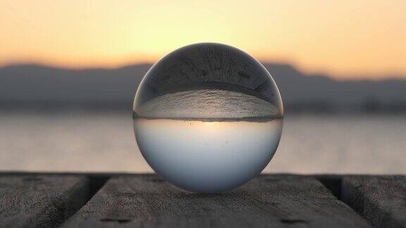 日落时水晶球上海滩的倒映