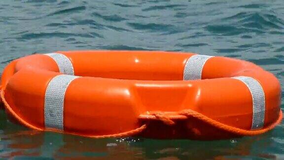 一个红色救生圈的特写镜头漂浮在水面上