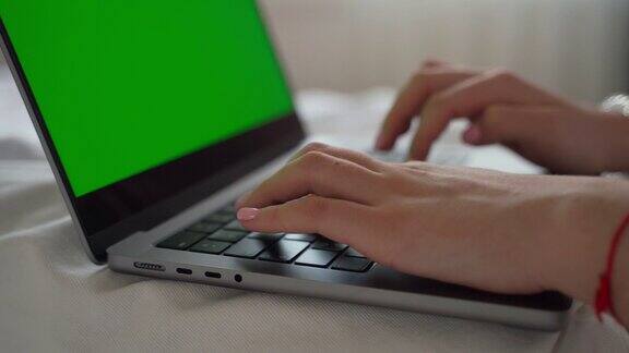 接近十几岁的女孩的手打字键盘使用笔记本电脑绿屏色度键学生毕业论文考试时间在线教育数字课网络课在家用电脑发信息虚拟教育女学生正在做作业