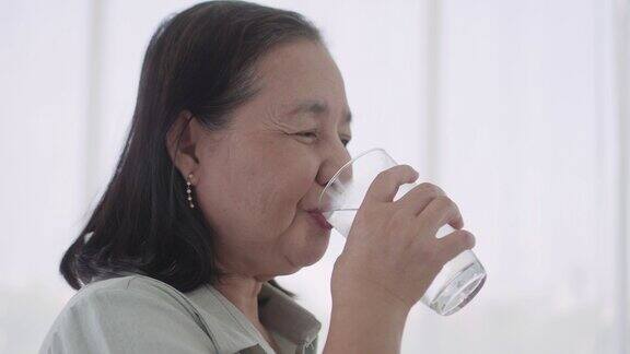 老妇人喝着一杯水