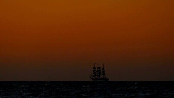 日落时海面上一艘高高的船的剪影