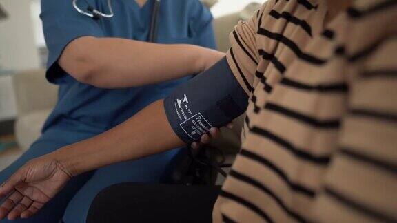 家访时护士佩戴防护口罩为老年病人测血压