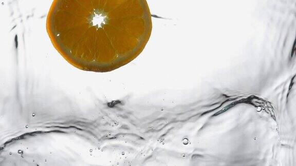橙滴入水中溅起水花的慢动作