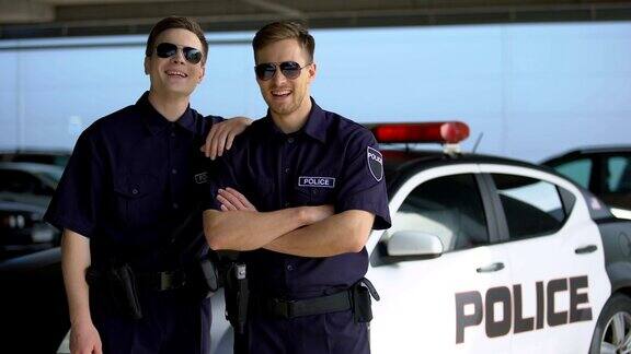 戴着太阳镜的警察同事们对着警车的镜头微笑工作