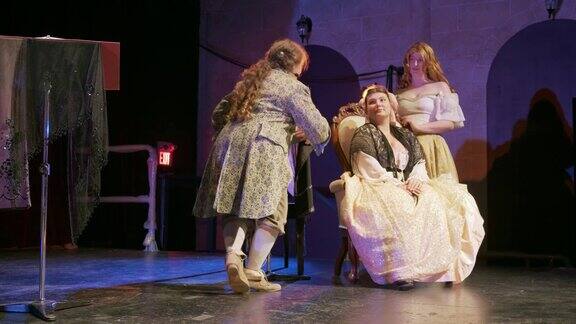 三位女演员在剧院舞台上穿着古装