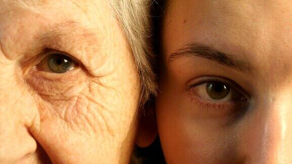 年老和年轻的眼睛-祖母和孙女一起看着照相机